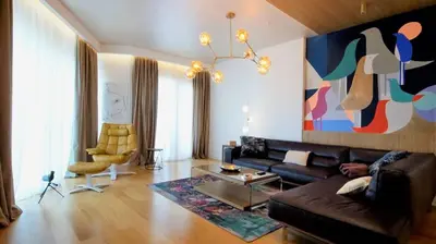 a living room with a couch and a painting on the wall at Vista Deluxe apartment - Tre Canne Budva in Budva