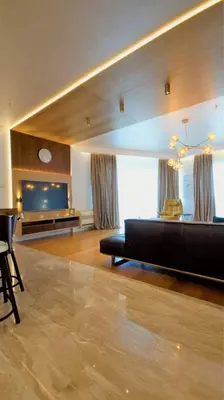 a living room with a black couch and a flat screen tv at Vista Deluxe apartment - Tre Canne Budva in Budva