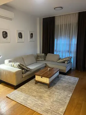 a living room with a couch and a coffee table at Apartmani Masa in Podgorica