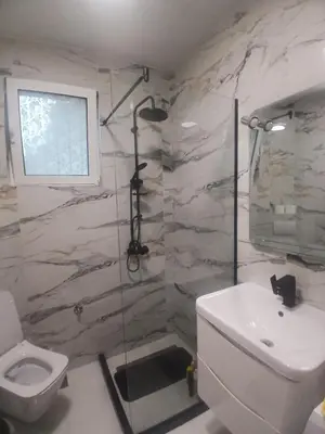 a bathroom with a white toilet and a sink at Kapa's House in Cetinje