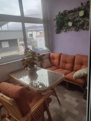 a living room with a couch and a glass table at Bar ,2 sobni stan ,Namaste ! in Bar