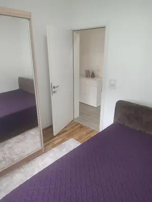 a bedroom with a purple bed and a mirror at Bar ,2 sobni stan ,Namaste ! in Bar
