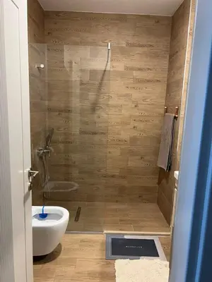 a bathroom with a shower with a toilet and a sink at Studio UNA - PMTR Building, BAR in Bar