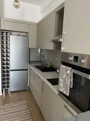 a kitchen with white cabinets and a white refrigerator at Studio UNA - PMTR Building, BAR in Bar
