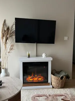 a living room with a fireplace with a television above it at Studio UNA - PMTR Building, BAR in Bar