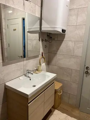 a bathroom with a sink and a mirror at Studio UNA - PMTR Building, BAR in Bar