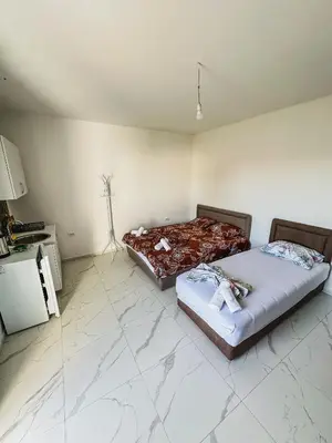 two beds sitting in a room with at Gzim Peja in Ulcinj