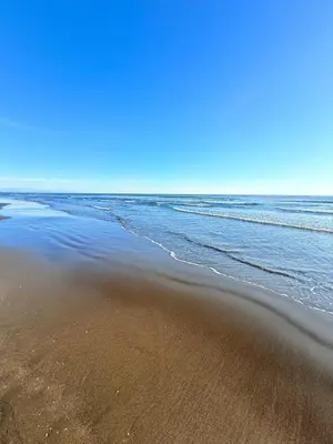 a sandy beach with the ocean in the background at Gzim Peja in Ulcinj