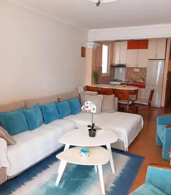 a living room with a white couch and a table at Seaview Rafailovici in Rafailovici