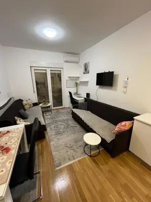 a living room with a couch and a table at Apartment Mirabella in Podgorica