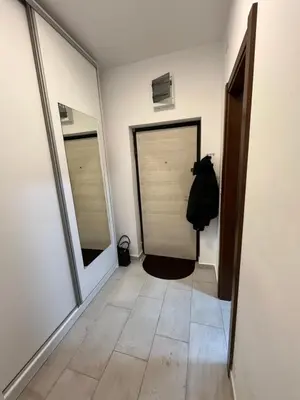 a hallway with two mirrors and a door at Apartment Mirabella in Podgorica