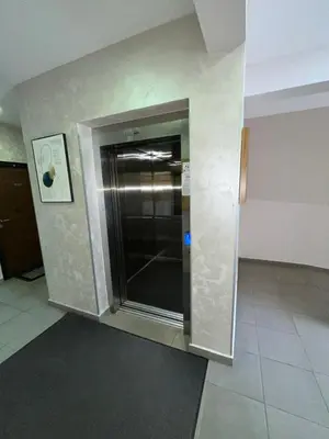 a stainless steel elevator in a room with a wall at Apartment Mirabella in Podgorica