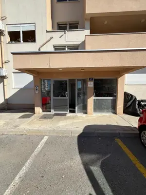 a building with the doors open on a street at Apartment Mirabella in Podgorica