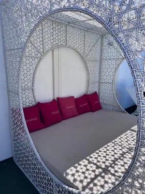a circular bed with red pillows in a room at Spa apartment Residence, with 2 pools and jacuzzi in Golubovci