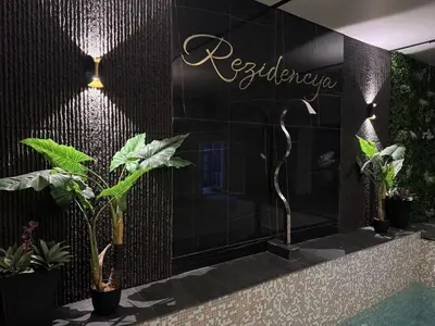a sign on a wall with plants on it at Spa apartment Residence, with 2 pools and jacuzzi in Golubovci