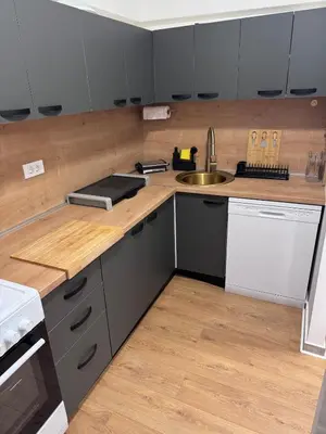 a kitchen with a sink and a counter top at Spa apartment Residence, with 2 pools and jacuzzi in Golubovci