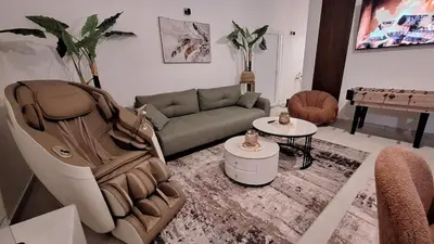 a living room with a couch and a table at Spa apartment Residence, with 2 pools and jacuzzi in Golubovci