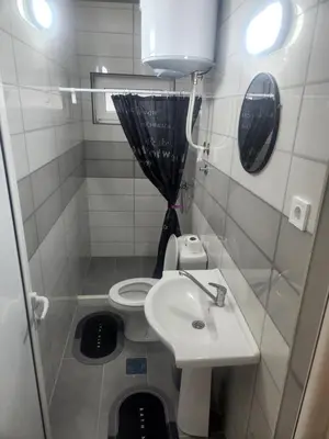 a small bathroom with a sink and a toilet at Morska Oaza Sutomore in Sutomore