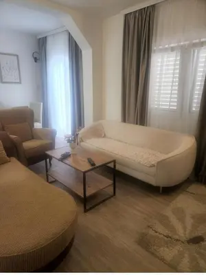 a living room with a couch and a coffee table at Morska Oaza Sutomore in Sutomore