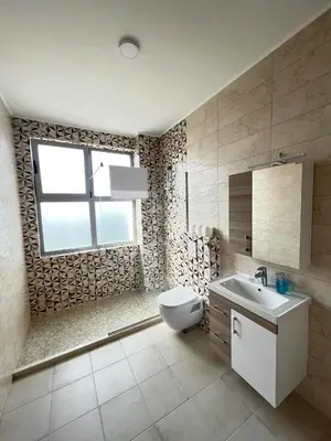 a bathroom with a toilet and a sink and a window at Mir i More in Dobra Voda