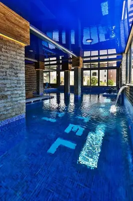 a large swimming pool in a building at Hotel & SPA Ricardo Residence in Ulcinj
