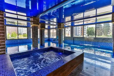 a large indoor swimming pool with a large tub at Hotel & SPA Ricardo Residence in Ulcinj