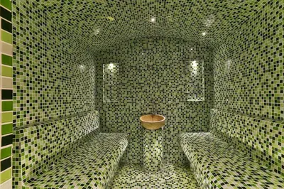 a tiled bathroom with two benches and a sink at Hotel & SPA Ricardo Residence in Ulcinj
