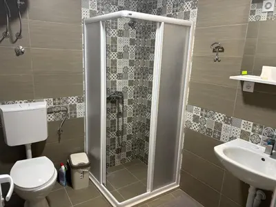 a bathroom with a shower and a toilet and a sink at Njaro del Mar Zukovica 2 in Žukovica