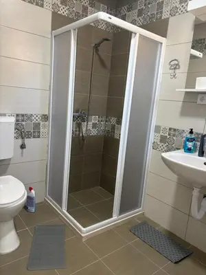a shower in a bathroom with a toilet and a sink at Njaro del Mar Zukovica 2 in Žukovica