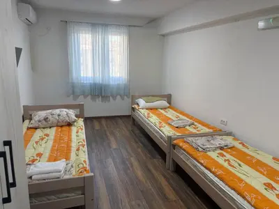 two beds in a room with a window at Njaro del Mar Zukovica 2 in Žukovica
