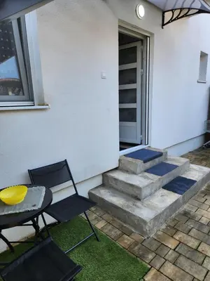 a patio with stairs and a table and chairs at Broj 4 in Podgorica