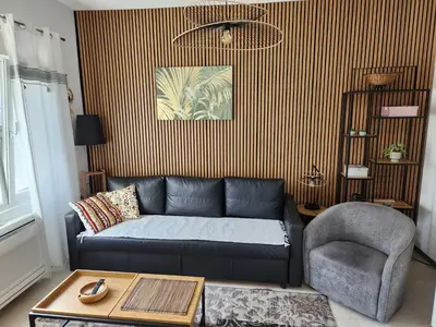 a living room with a couch and a chair at Broj 4 in Podgorica