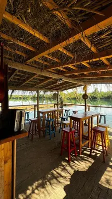 a group of tables and chairs under a roof at Costa Del Rio in Bistrice