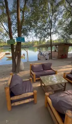 a patio with couches and a table and a lake at Costa Del Rio in Bistrice