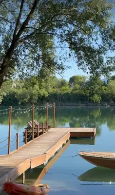 a dock and a boat on a lake at Costa Del Rio in Bistrice