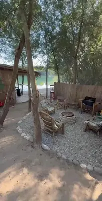 a picnic area with benches and a fire pit at Costa Del Rio in Bistrice