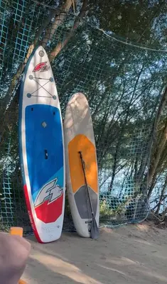 three surfboards are leaning up against a fence at Costa Del Rio in Bistrice