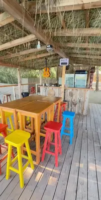 a wooden table and chairs on a wooden deck at Costa Del Rio in Bistrice