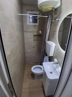 a small bathroom with a toilet and a sink at Studio19 in Podgorica