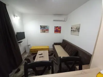 a living room with a couch and a table at Studio19 in Podgorica