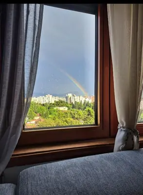 a view of a rainbow from a bedroom window at Apartman Podgorica - Pobrezje in Podgorica