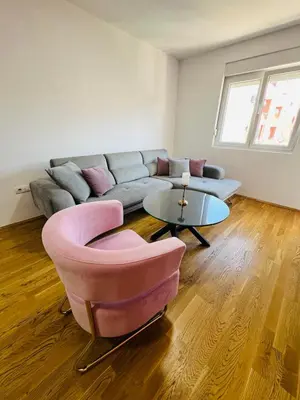 a living room with a couch and a table at Royal Stay Podgorica - Princess Apartment in Podgorica