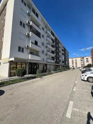 an empty street in front of a large building at Royal Stay Podgorica - Princess Apartment in Podgorica