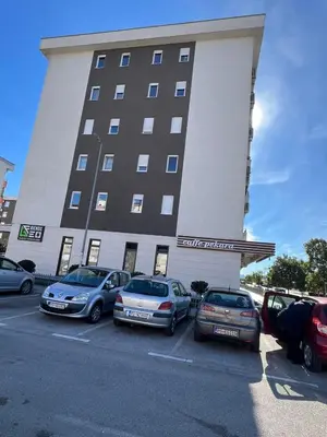 a group of cars parked in front of a building at Royal Stay Podgorica - Princess Apartment in Podgorica
