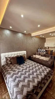 a bedroom with a large bed and a couch at Etihad Apartments&Spa in Ulcinj