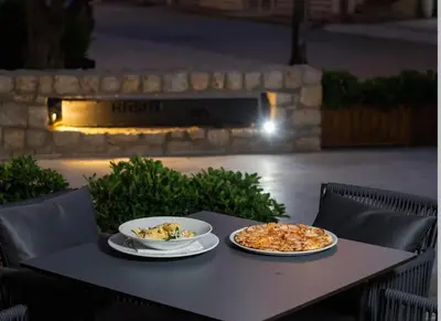 two plates of food are sitting on a table at Etihad Apartments&Spa in Ulcinj