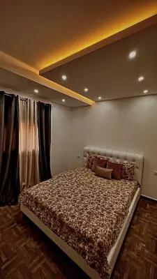 a bedroom with a large bed in front of a window at Etihad Apartments&Spa in Ulcinj