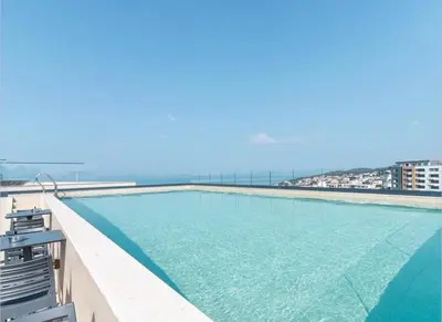 a swimming pool with a view of the ocean at Etihad Apartments&Spa in Ulcinj