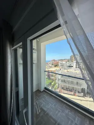a room with a large window with a view of a city at Etihad Apartments&Spa in Ulcinj