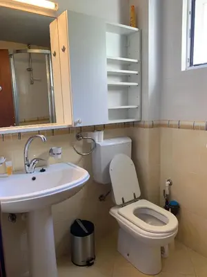 a bathroom with a white toilet and a sink at Appartement centre avec garage privé in Budva